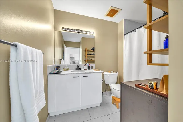 a kitchen with a refrigerator and a stove top oven