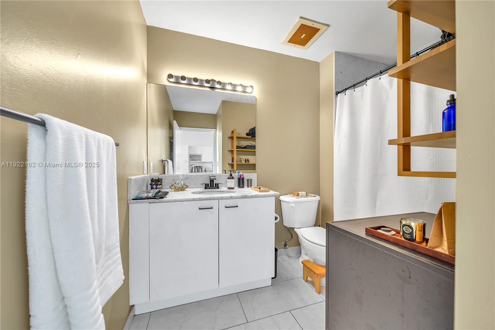 133 Northeast 2nd Avenue, Unit 2917 Miami, FL 33132 - Photo 11 of 13 a kitchen with a refrigerator and a stove top oven