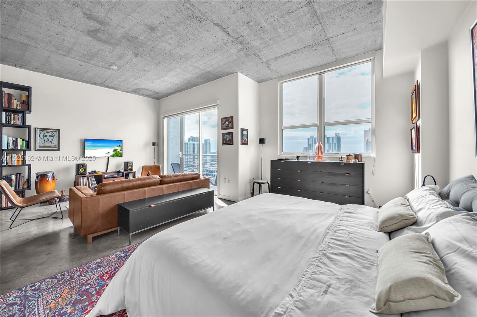 133 Northeast 2nd Avenue, Unit 2917 Miami, FL 33132 - Photo 2 of 13 a bedroom with a bed couch and a large window