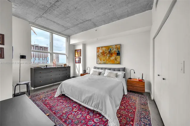 a bedroom with a bed and dresser