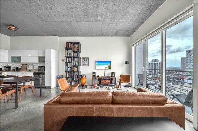 a bedroom with furniture and large window