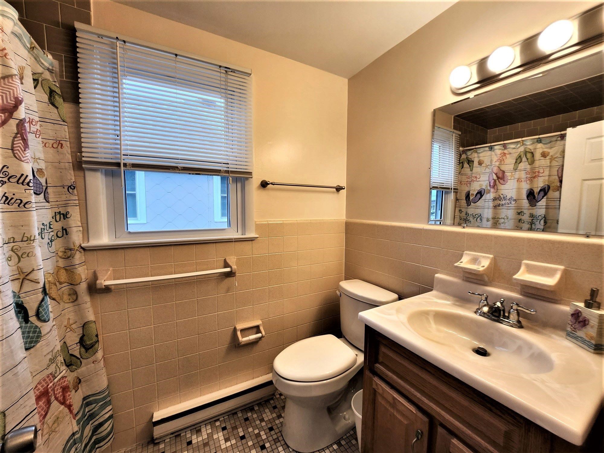 9903 2nd Stone Harbor, NJ 08247 - Photo 17 of 28 a bathroom with a sink toilet and mirror
