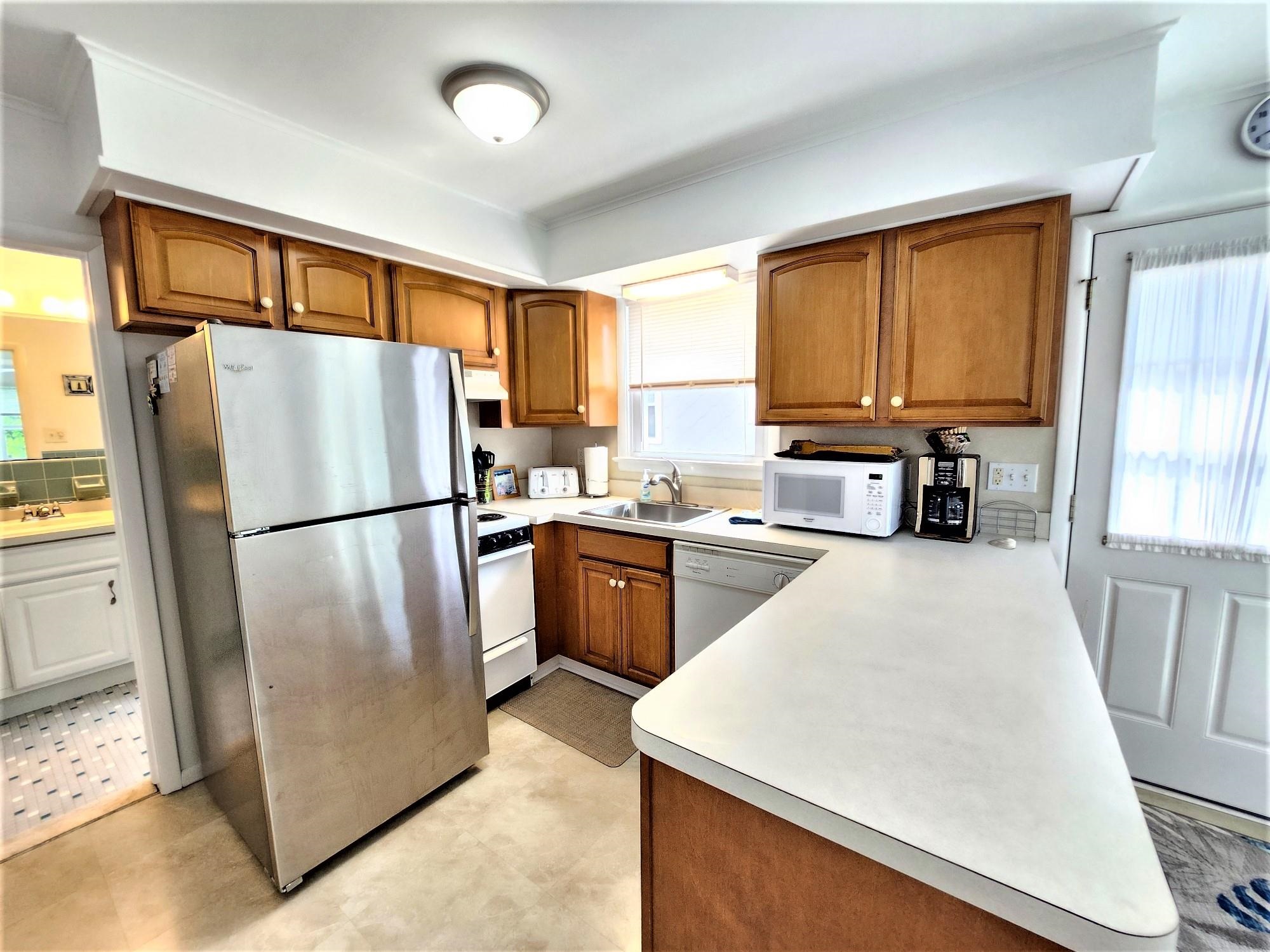 9903 2nd Stone Harbor, NJ 08247 - Photo 19 of 28 a kitchen with a refrigerator a stove top oven and a refrigerator