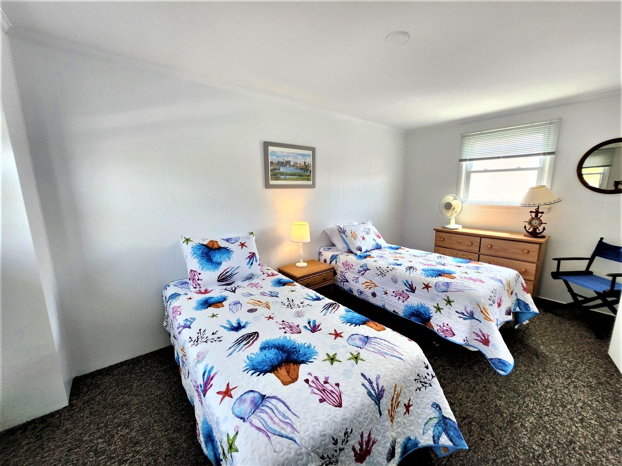 9903 2nd Stone Harbor, NJ 08247 - Photo 24 of 28 a bedroom with two beds and a lamp on dresser