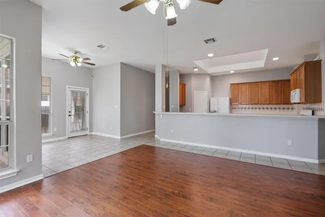 a view of a kitchen with a sink and a refrigerator