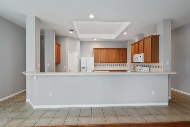 a view of kitchen with stainless steel appliances cabinets and window