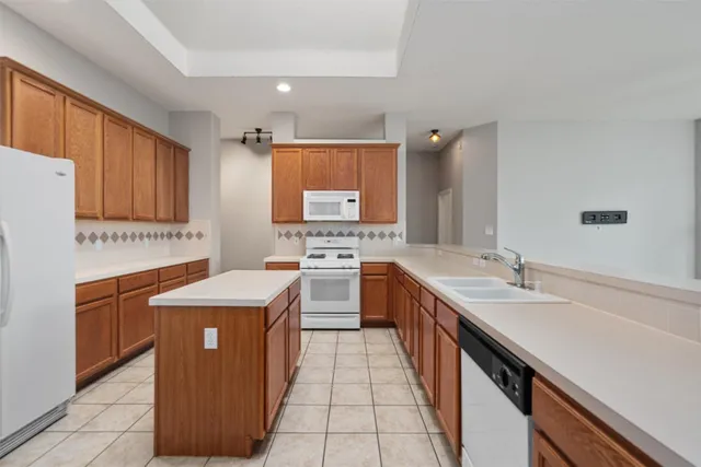 a kitchen with stainless steel appliances granite countertop a sink counter space cabinets and a large window