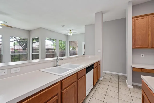 a kitchen with a sink and large window