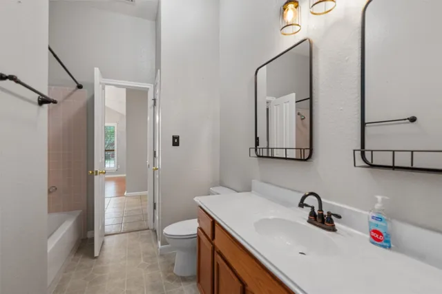 a bathroom with a toilet sink and mirror