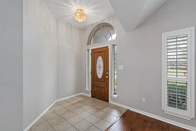 an empty room with windows closet and mirror