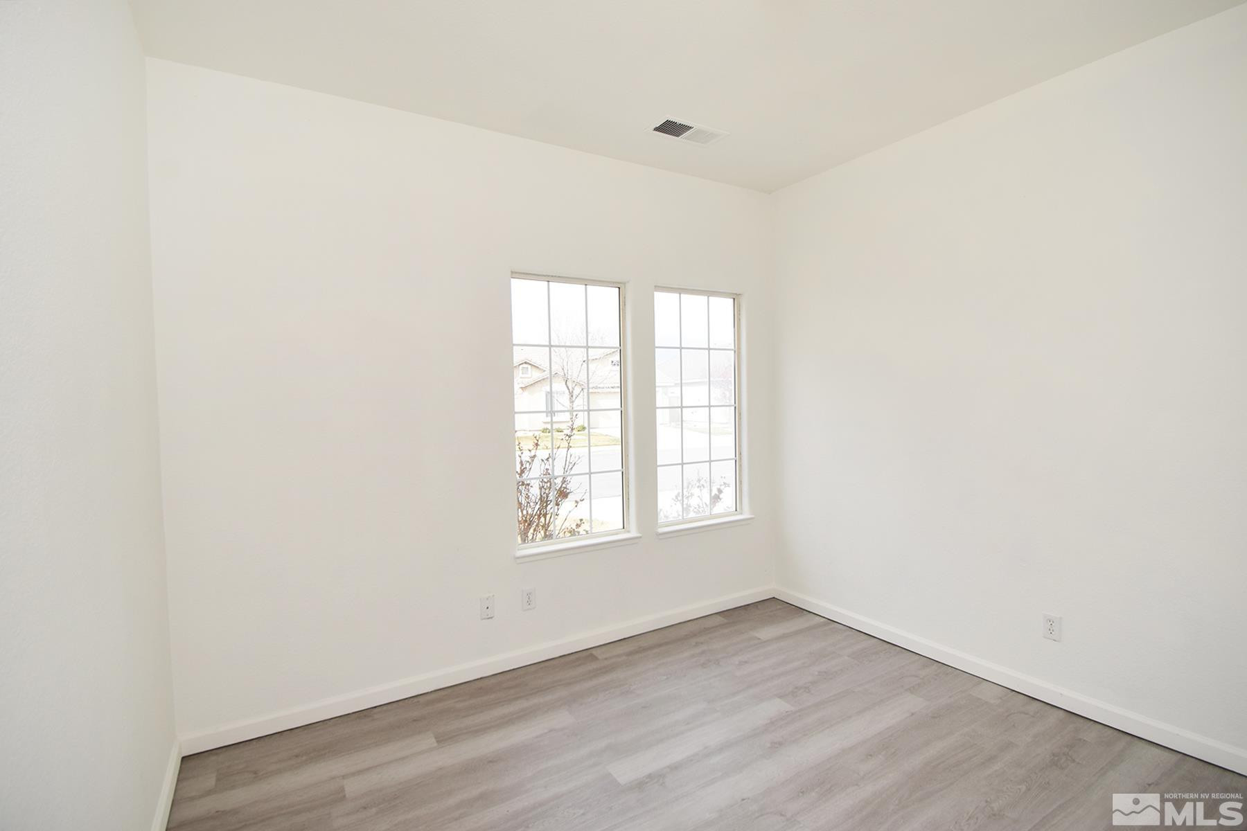 1650 Canyonlands Way Reno, NV 89521 - Photo 20 of 25 an empty room with wooden floor and windows