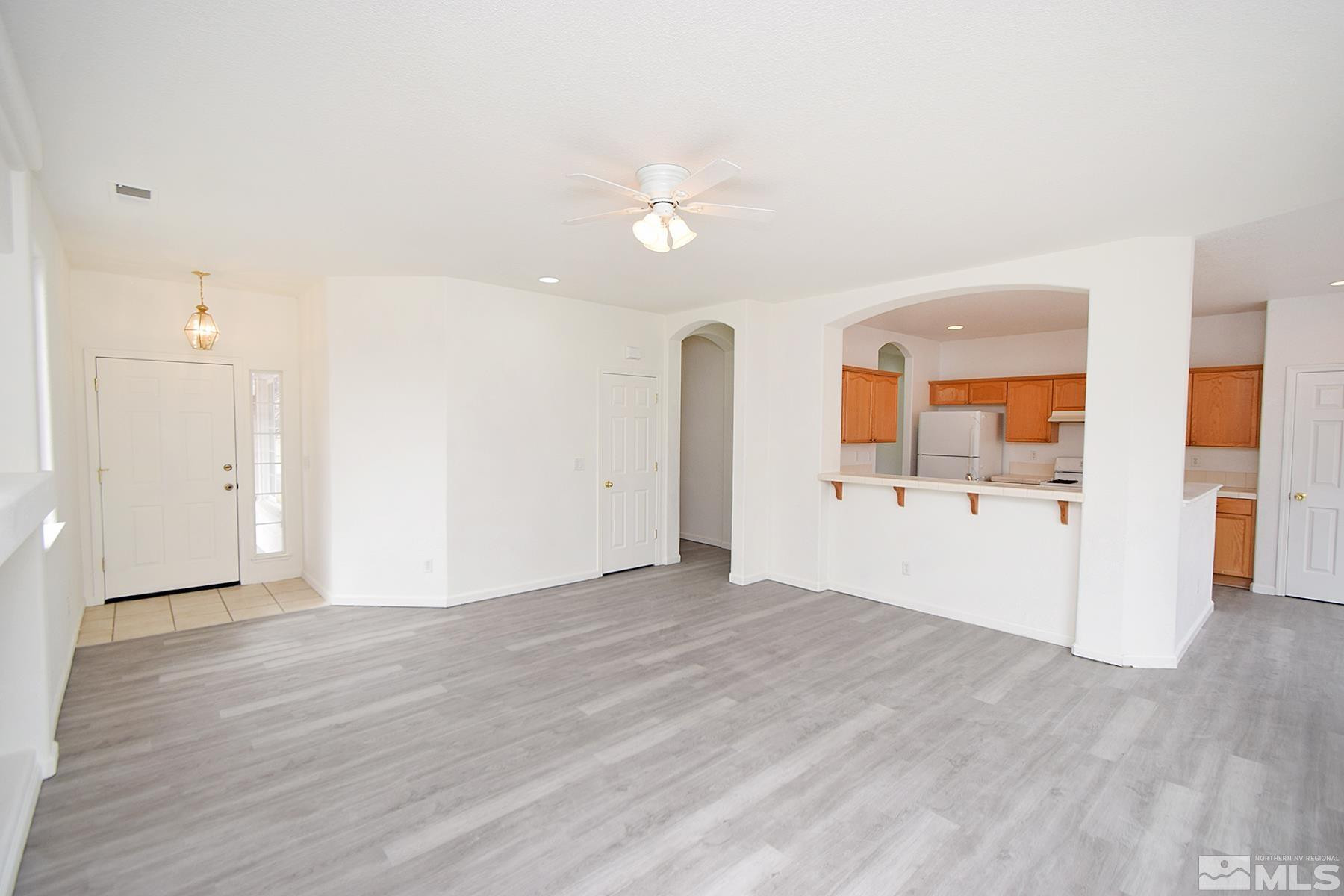 1650 Canyonlands Way Reno, NV 89521 - Photo 2 of 25 an empty room with wooden floor and windows