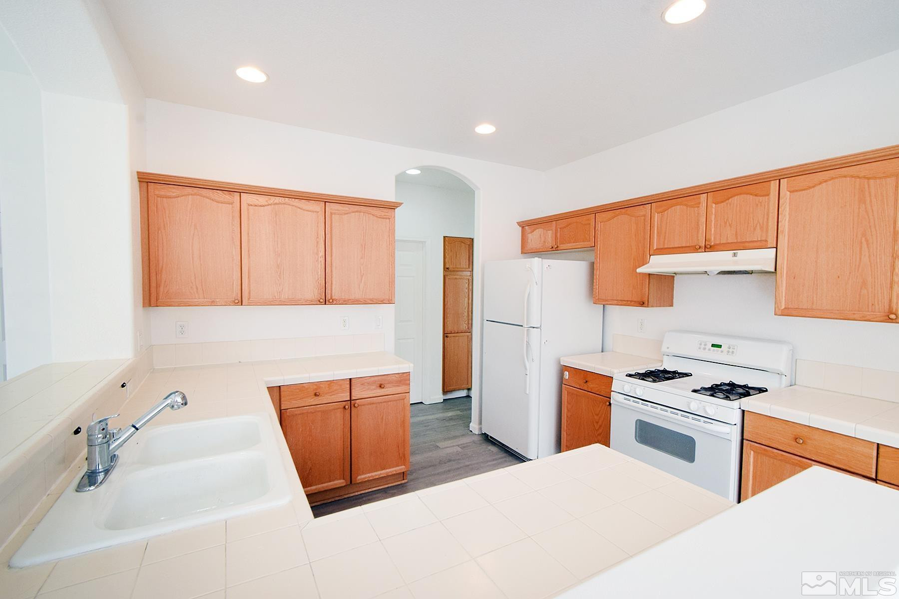 1650 Canyonlands Way Reno, NV 89521 - Photo 8 of 25 a kitchen with stainless steel appliances a stove a sink and a refrigerator