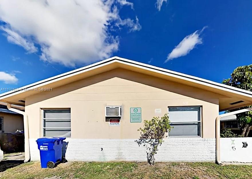 Avondale Pompano Beach, FL 33060 - Photo 15 of 18 a front view of a house with a garage