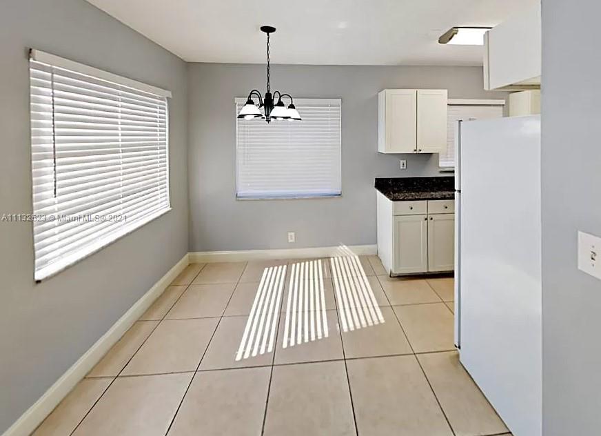 Avondale Pompano Beach, FL 33060 - Photo 2 of 18 a view of kitchen and empty room with windows