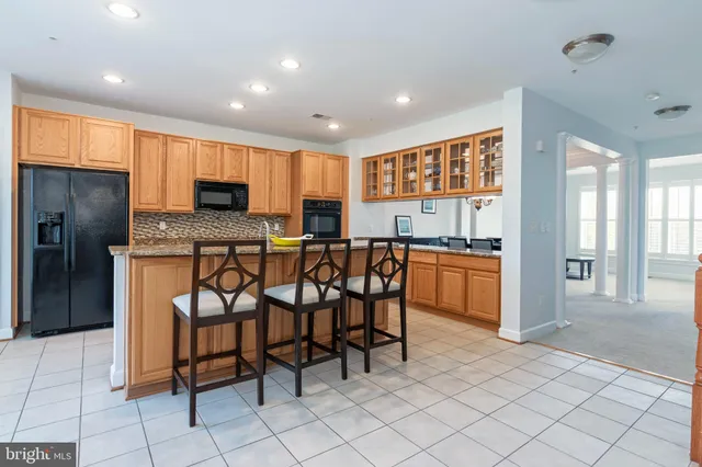 a kitchen with stainless steel appliances granite countertop a sink counter space cabinets and a large window