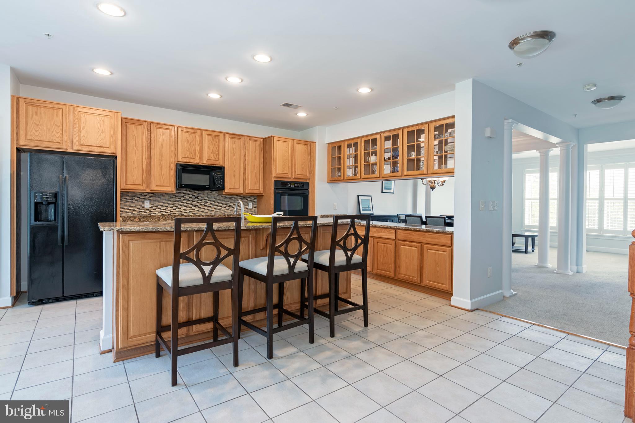 2804 Persimmon Place, Unit D3 Cambridge, MD 21613 - Photo 11 of 49 a kitchen with stainless steel appliances a refrigerator and a stove top oven
