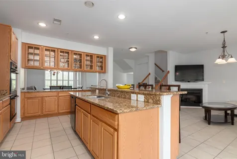 a kitchen with stainless steel appliances granite countertop a refrigerator stove microwave and sink
