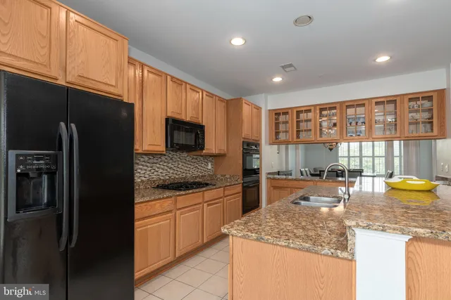 a kitchen with granite countertop white cabinets and stainless steel appliances