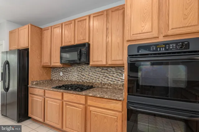 a kitchen with granite countertop a sink and cabinets