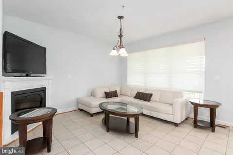 a front view of a building with a garden and plants