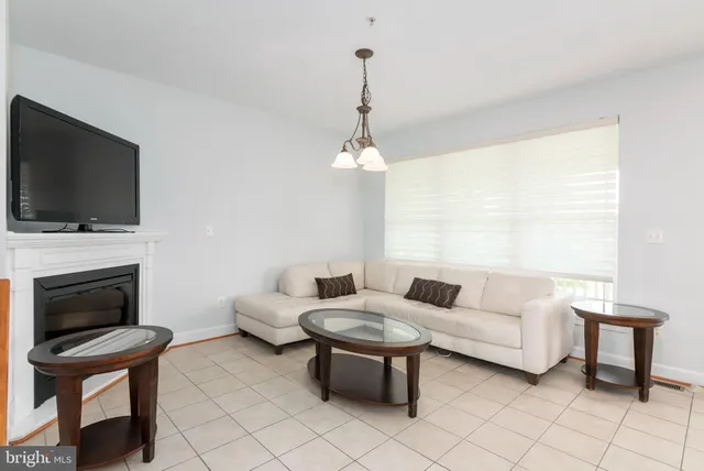 a front view of a building with a garden and plants