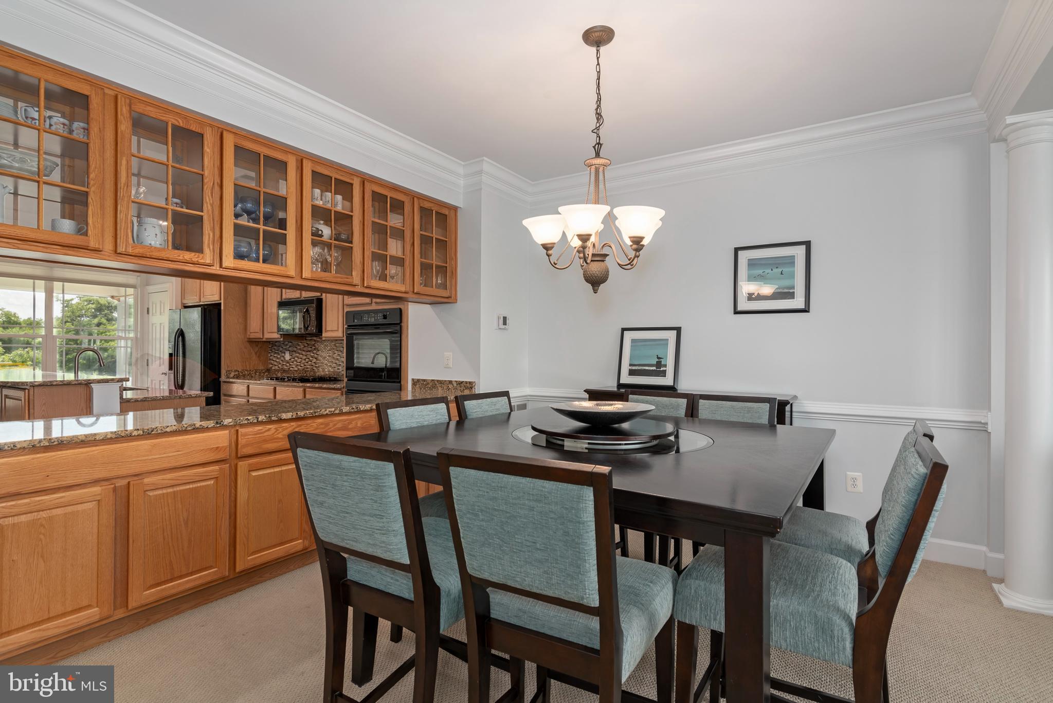 2804 Persimmon Place, Unit D3 Cambridge, MD 21613 - Photo 2 of 49 a view of a dining room with furniture a chandelier and wooden floor