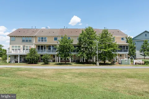 front view of a house with a yard deck and furniture