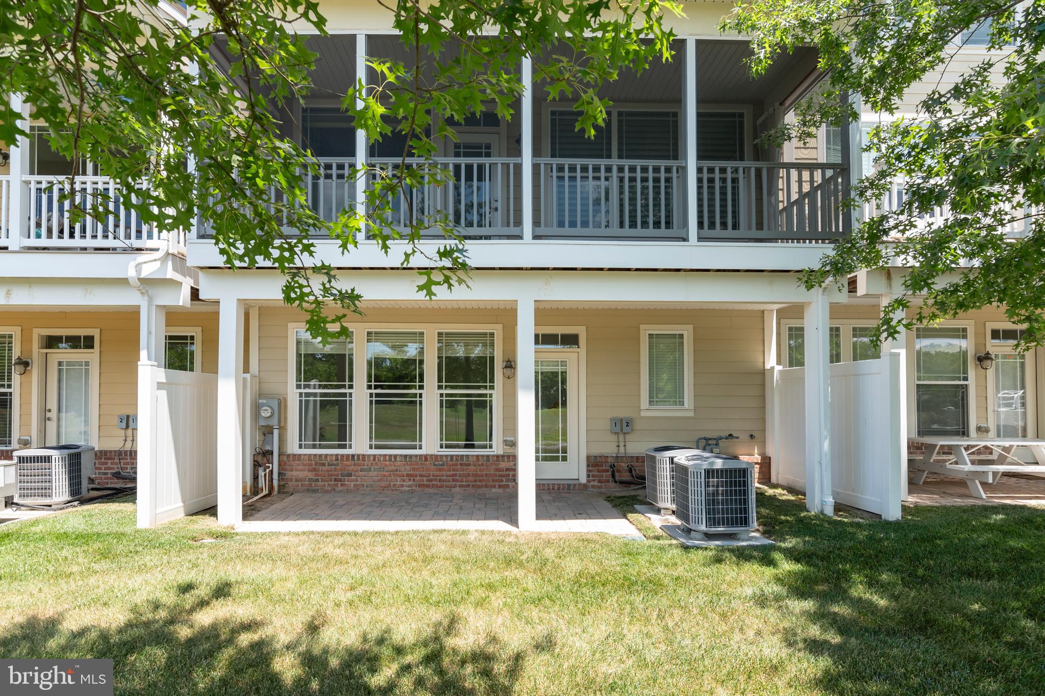 2804 Persimmon Place, Unit D3 Cambridge, MD 21613 - Photo 26 of 49 front view of a house with a yard deck and furniture