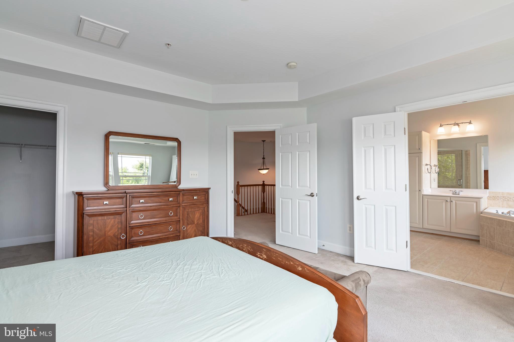 2804 Persimmon Place, Unit D3 Cambridge, MD 21613 - Photo 31 of 49 a bedroom with a bed and cabinets