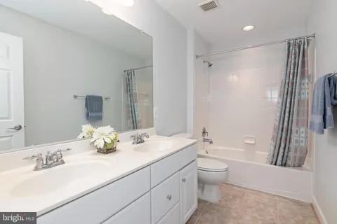 a bedroom with a bed and a large window with outer view