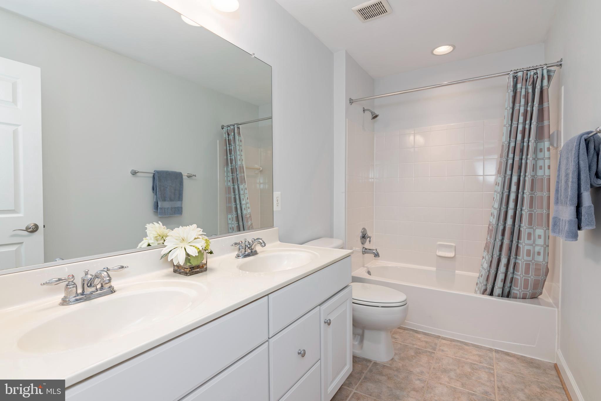 2804 Persimmon Place, Unit D3 Cambridge, MD 21613 - Photo 36 of 49 a bathroom with a granite countertop sink toilet and shower