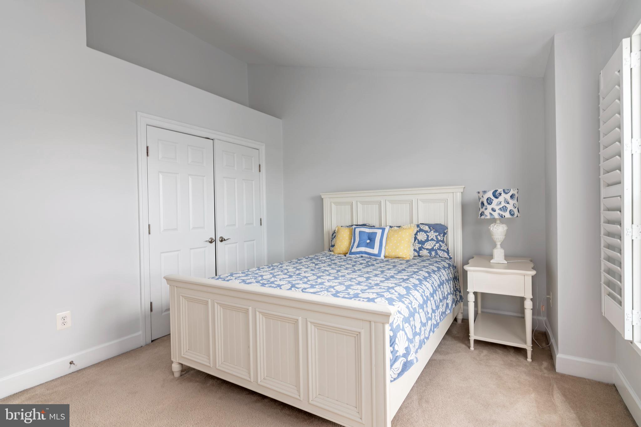 2804 Persimmon Place, Unit D3 Cambridge, MD 21613 - Photo 38 of 49 a bedroom with a bed and a table in it