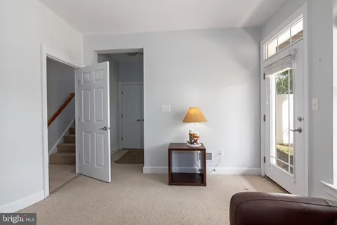 a bathroom with a granite countertop toilet a sink and a mirror