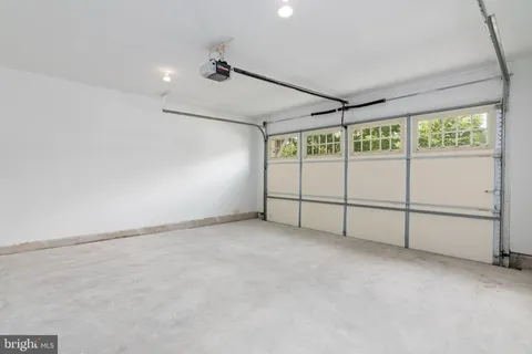 a view of a patio with a table and chairs in front of a house