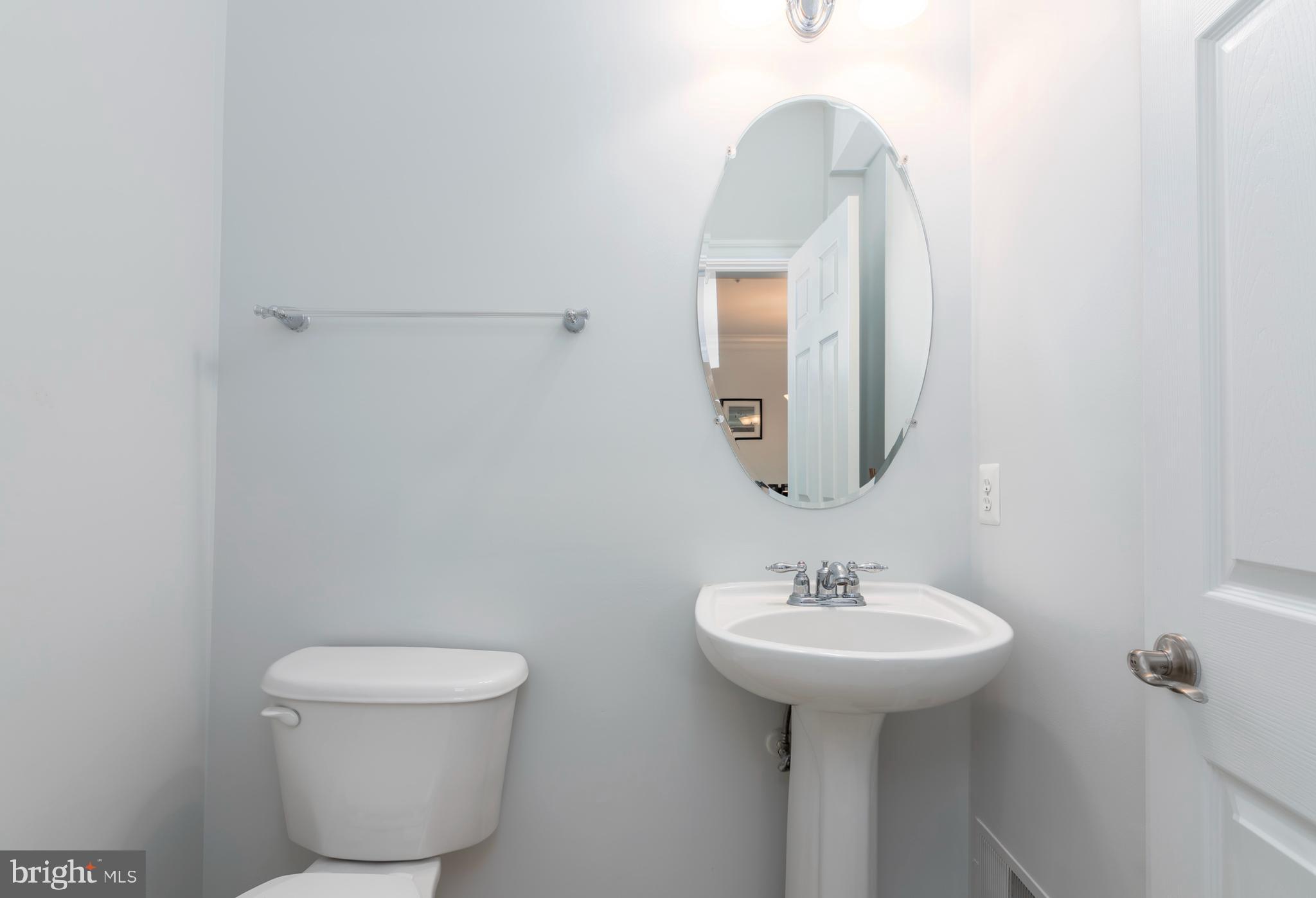 2804 Persimmon Place, Unit D3 Cambridge, MD 21613 - Photo 8 of 49 a bathroom with a toilet sink and mirror