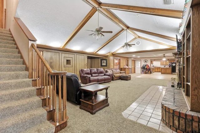 a living room with lots of furniture and a chandelier