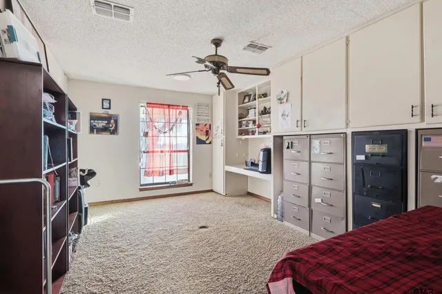 a bedroom with a bed dresser and a window