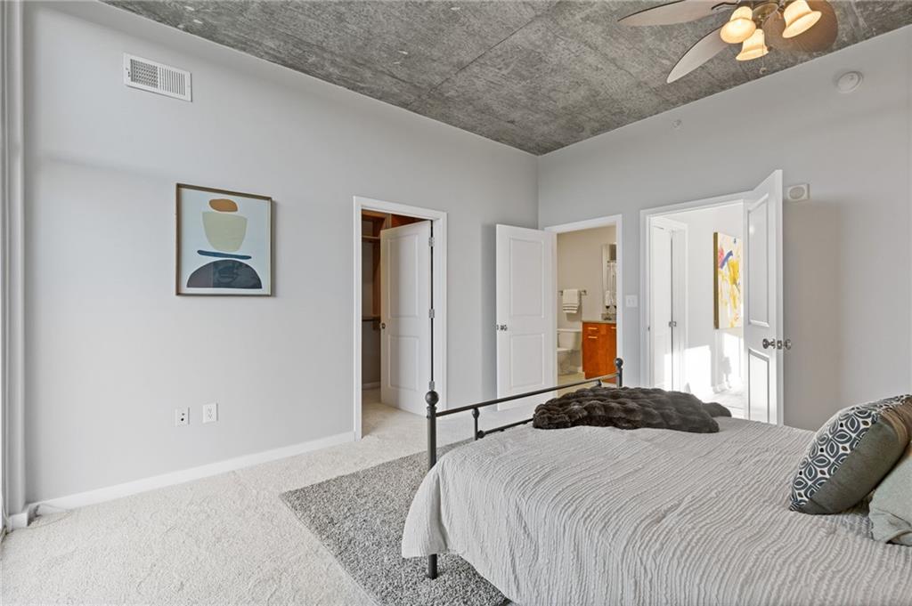 3300 Windy Ridge Parkway Southeast, Unit 621 Atlanta, GA 30339 - Photo 12 of 39 a bedroom with a bed and a couch