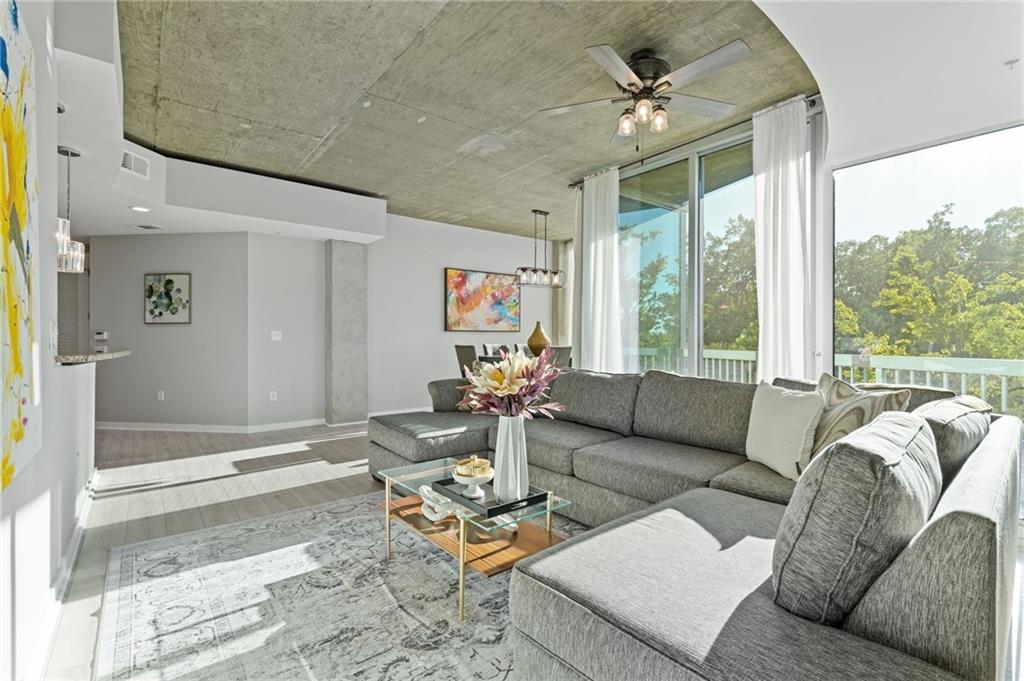 3300 Windy Ridge Parkway Southeast, Unit 621 Atlanta, GA 30339 - Photo 9 of 39 a living room with furniture and a large window