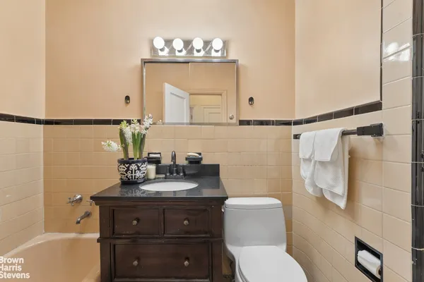 a spacious bathroom with a double vanity sink a mirror and a shower