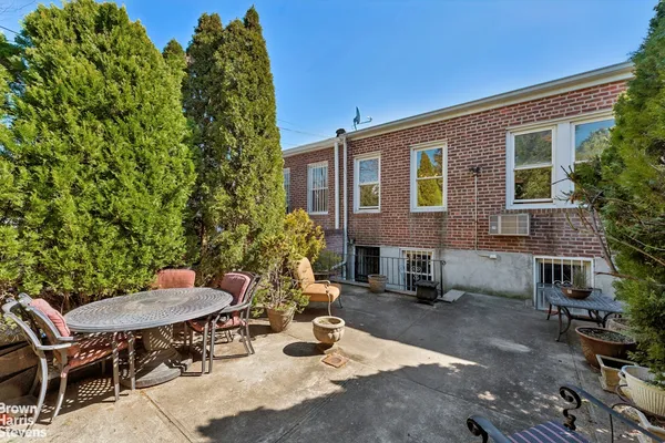 a backyard of a house with table and chairs