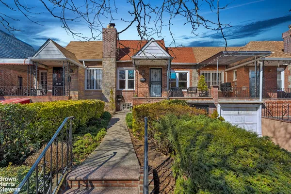 a backyard of a house with fire pit and outdoor seating