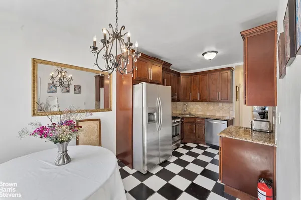 a kitchen with granite countertop a sink stove and refrigerator