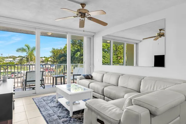 a living room with furniture and a floor to ceiling window