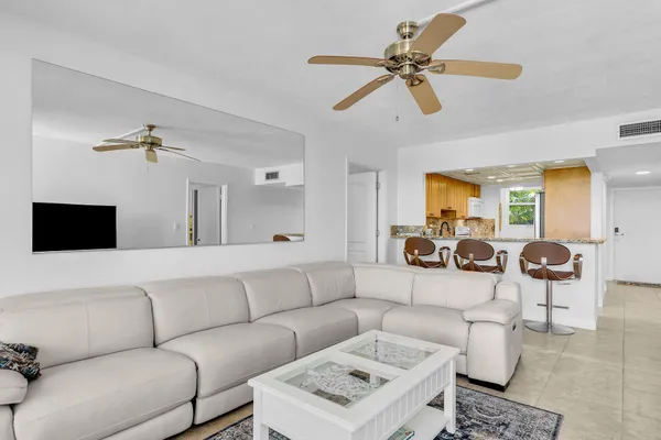 a living room with furniture a rug and a flat screen tv