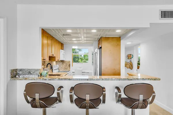 a bathroom with a granite countertop double vanity and a mirror