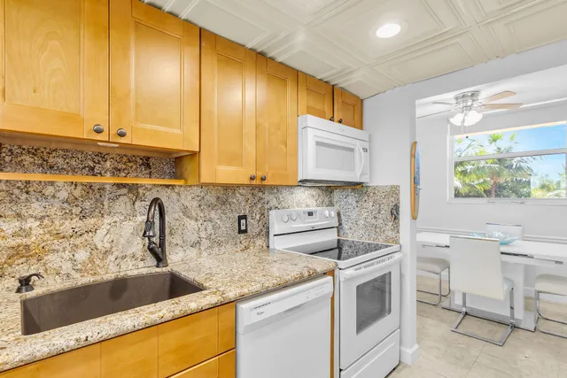 a kitchen with a sink cabinets and window