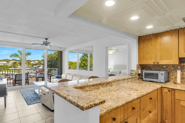 a kitchen with sink stove and cabinets
