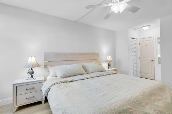 a bedroom with a bed and a lamp